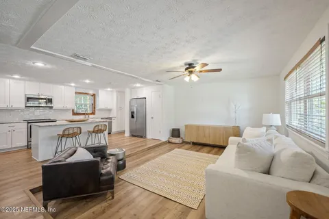 a living room with furniture and kitchen view