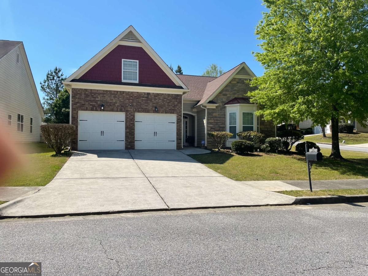 a front view of a house with a yard and garage