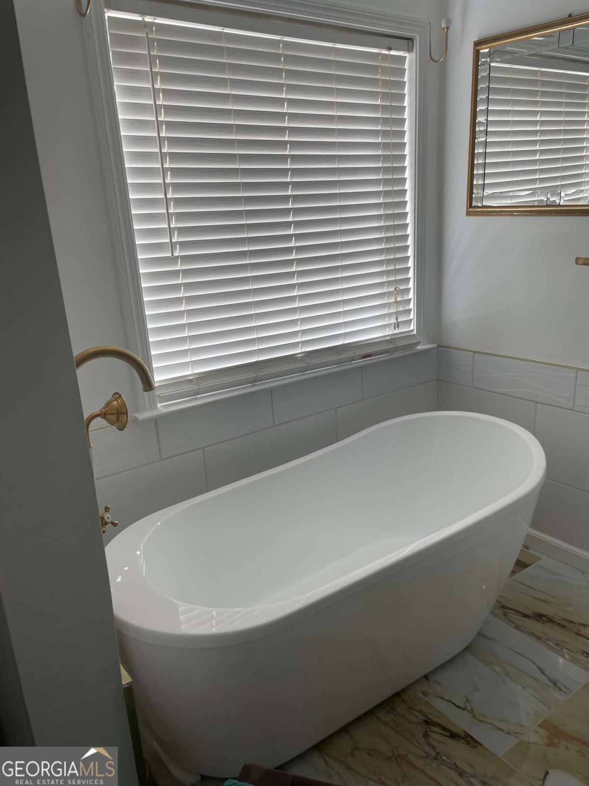 4230 Vinca Way Union City, GA 30291 - Photo 22 of 28 a white bath tub sitting in a bathroom