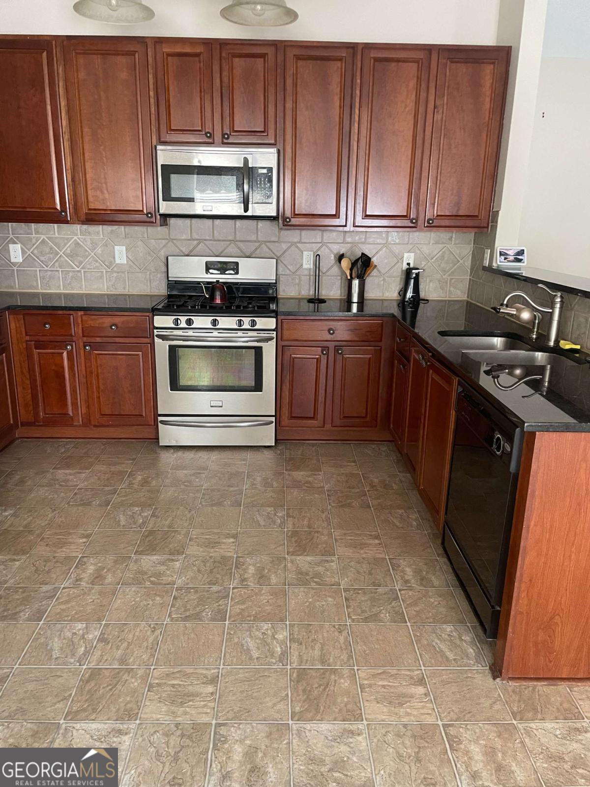 4230 Vinca Way Union City, GA 30291 - Photo 26 of 28 a kitchen with stainless steel appliances granite countertop a stove a sink dishwasher and a refrigerator