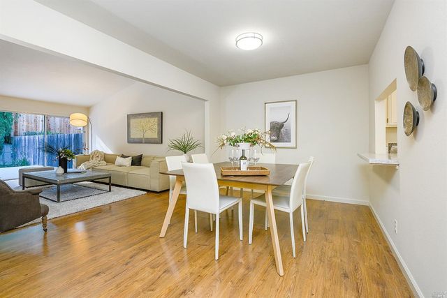 a dining room with wooden floor and breakfast area
