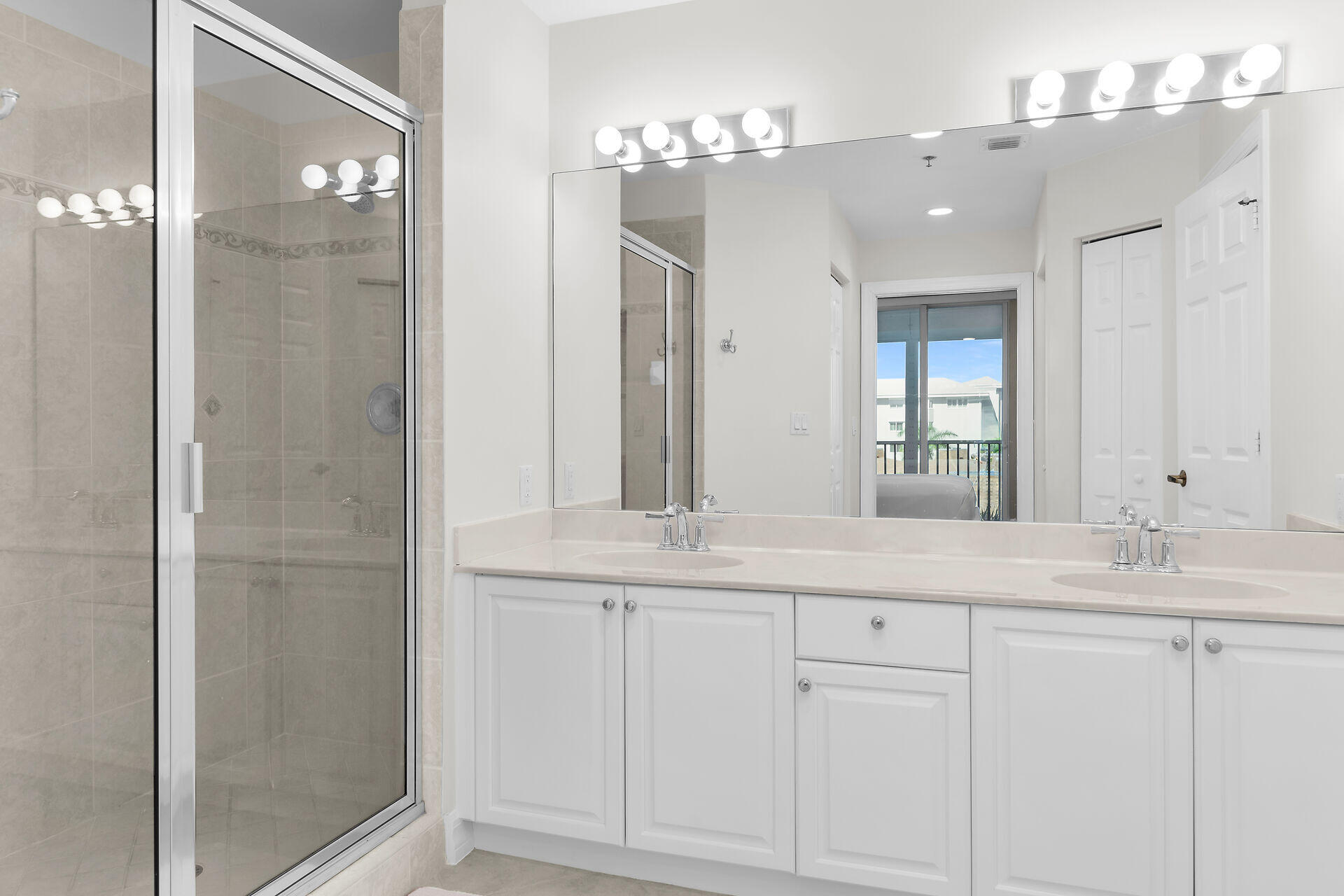 1111 Swallow Avenue, Unit 1401 Marco Island, FL 34145 - Photo 26 of 36 a bathroom with a double vanity sink and shower