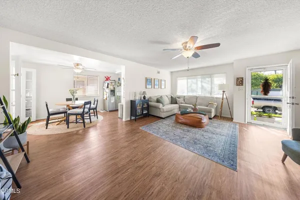a kitchen with stainless steel appliances granite countertop a stove and a wooden floors