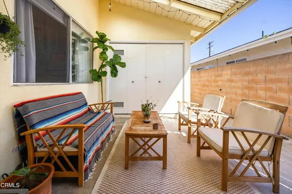 a front view of a house with outdoor seating