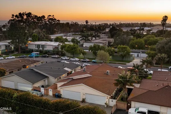 an aerial view of multiple houses with yard