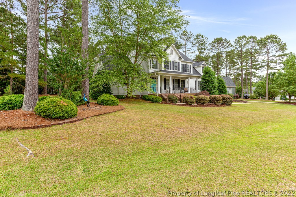126 Falling Water Road Spring Lake, NC 28390 - Photo 1 of 47 a front view of a building with a garden and trees