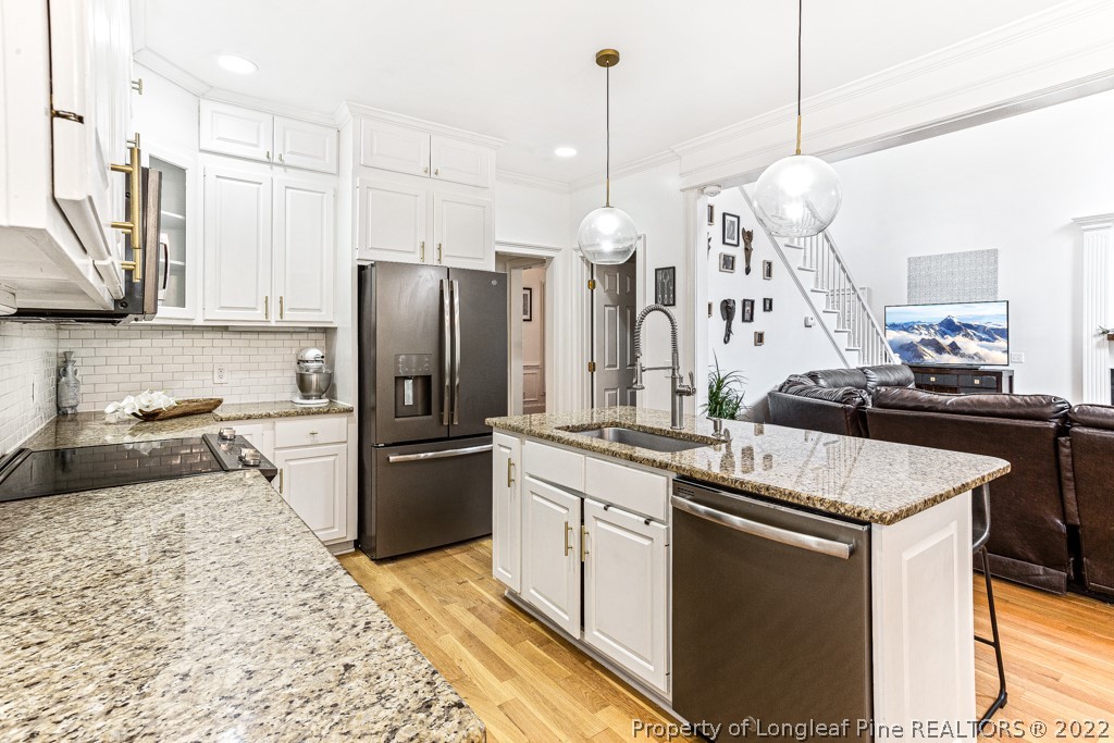 126 Falling Water Road Spring Lake, NC 28390 - Photo 28 of 47 a kitchen with stainless steel appliances granite countertop a sink a stove and a refrigerator