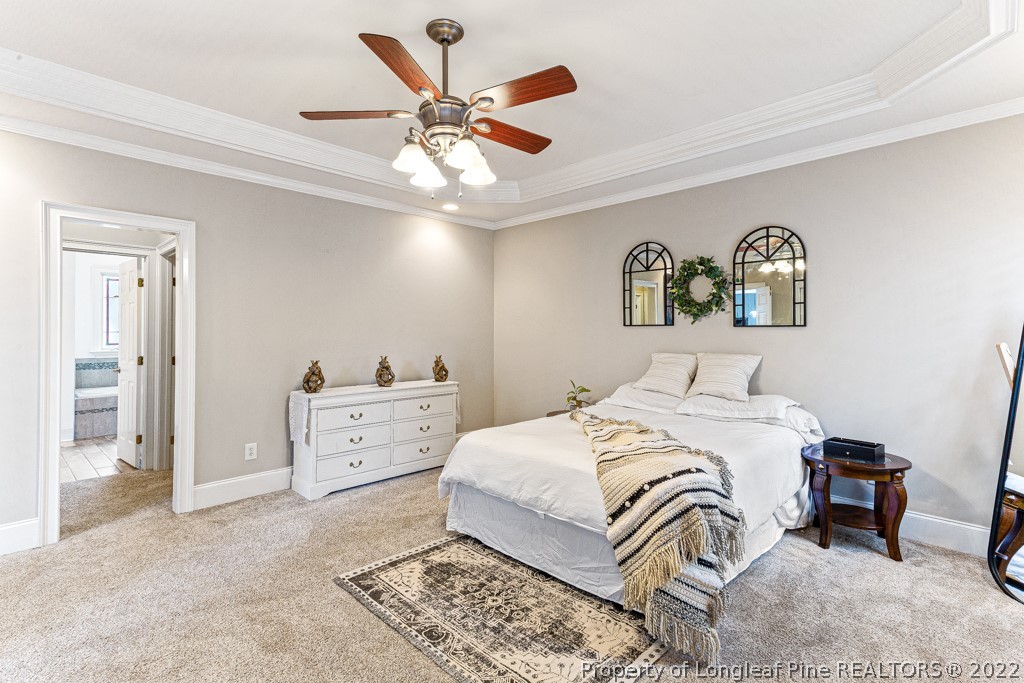 126 Falling Water Road Spring Lake, NC 28390 - Photo 33 of 47 a bedroom with a bed and a chandelier