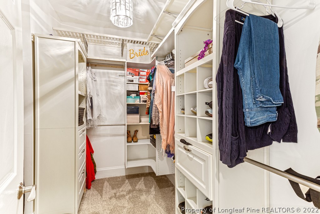 126 Falling Water Road Spring Lake, NC 28390 - Photo 36 of 47 a view of walk in closet with clothes and shoes