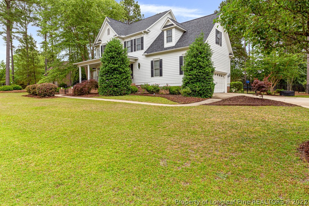 126 Falling Water Road Spring Lake, NC 28390 - Photo 4 of 47 a view of a house with pool and trees in the background
