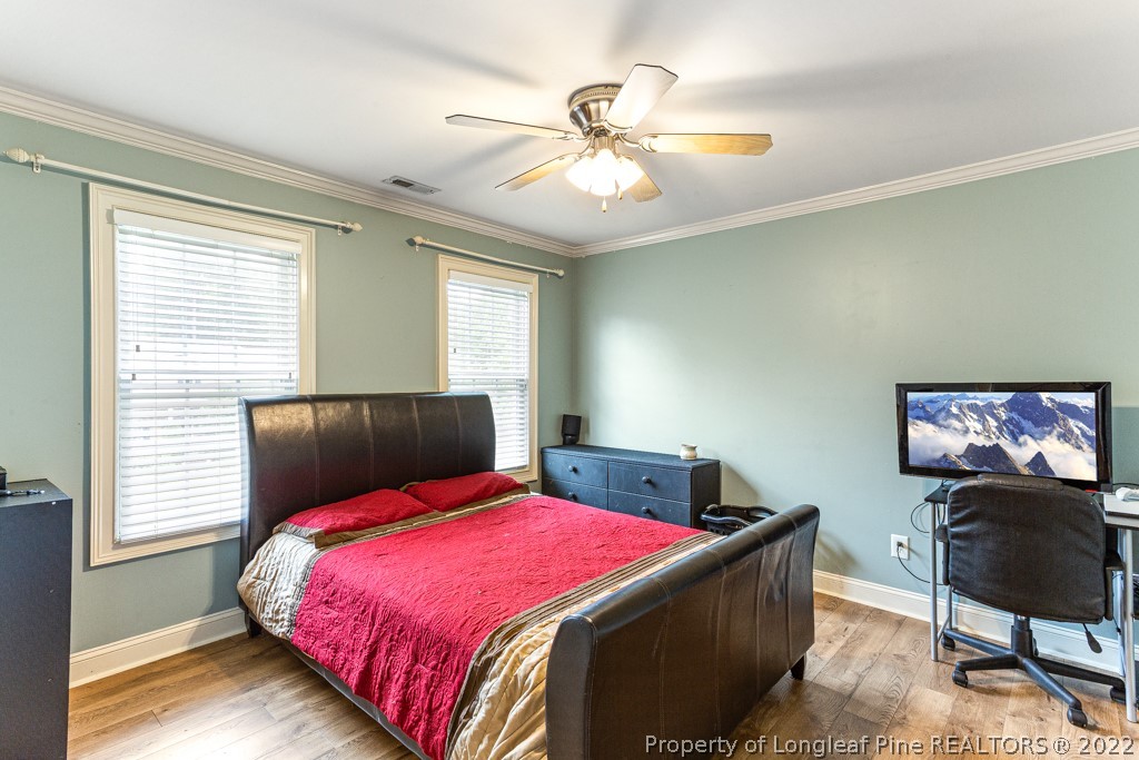 126 Falling Water Road Spring Lake, NC 28390 - Photo 42 of 47 a bedroom with a bed and a chandelier