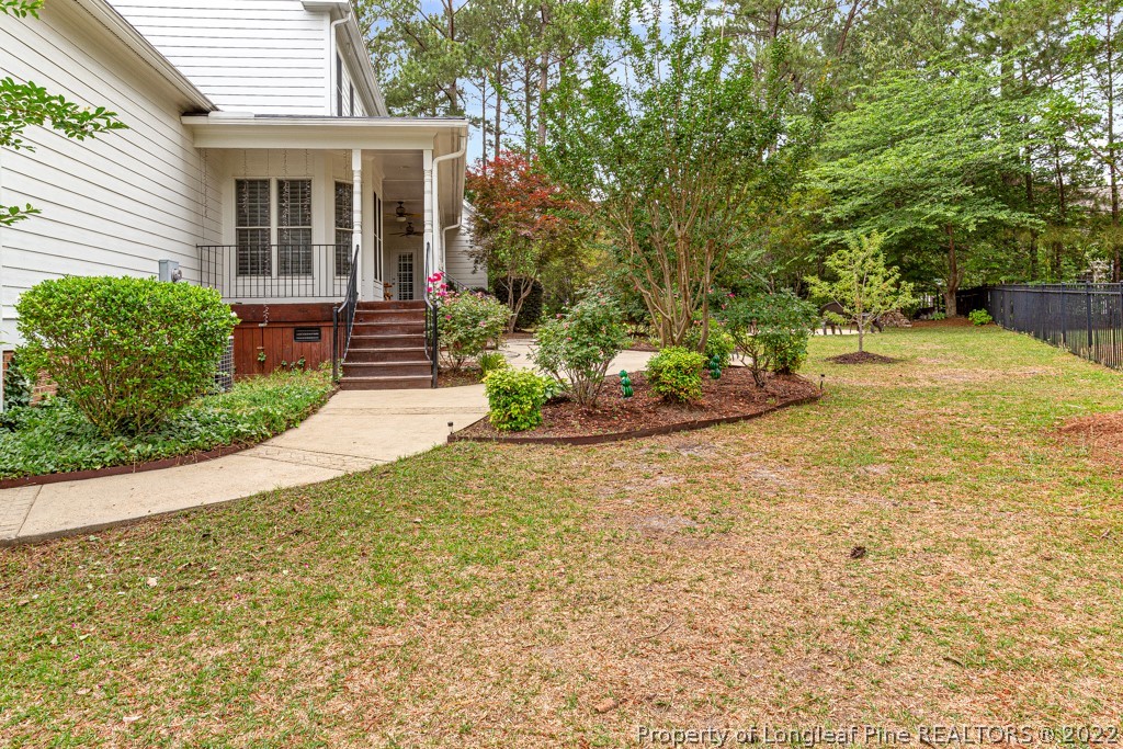 126 Falling Water Road Spring Lake, NC 28390 - Photo 5 of 47 a front view of a house with a yard and potted plants