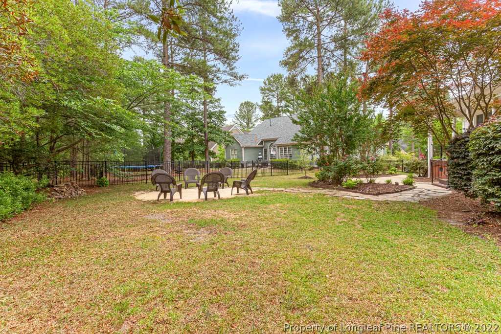 126 Falling Water Road Spring Lake, NC 28390 - Photo 9 of 47 a view of a swimming pool with a lawn chairs under an umbrella