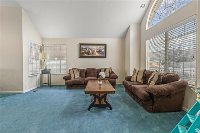 19 South 820 East Tooele, UT 84074 - Photo 10 of 46 Living area with vaulted ceiling, plenty of natural light, and carpet floors