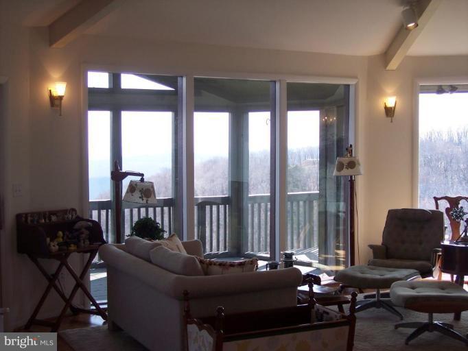 18500 Turkey Ridge Road Northeast Flintstone, MD 21530 - Photo 23 of 25 This LR area opens to screened porch & adjoins DR