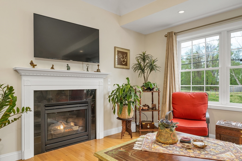 31 Danville Road Hampstead, NH 03826 - Photo 11 of 42 a living room with furniture a flat screen tv and a fireplace