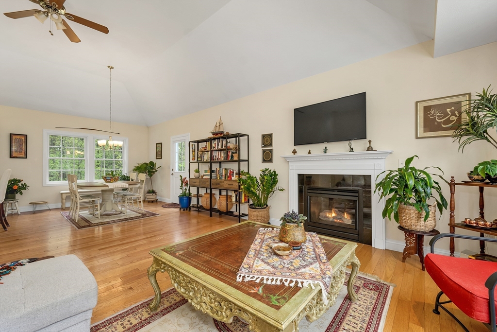 31 Danville Road Hampstead, NH 03826 - Photo 13 of 42 a living room with furniture a flat screen tv and a fireplace