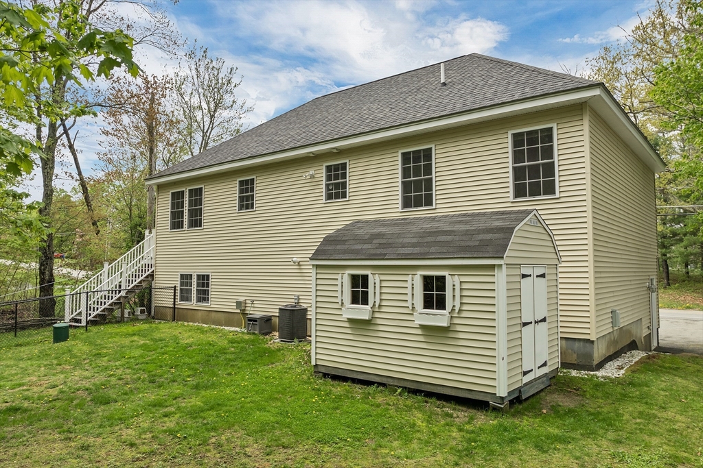31 Danville Road Hampstead, NH 03826 - Photo 2 of 42 a front view of a house with a yard