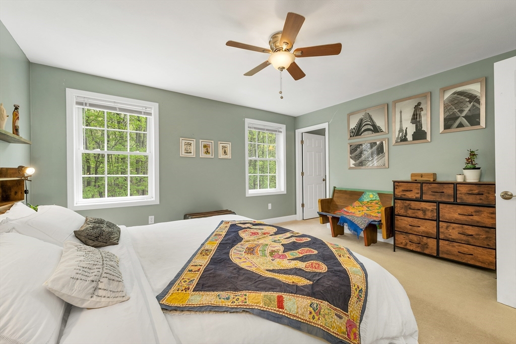 31 Danville Road Hampstead, NH 03826 - Photo 22 of 42 a bedroom with a bed and wooden floor
