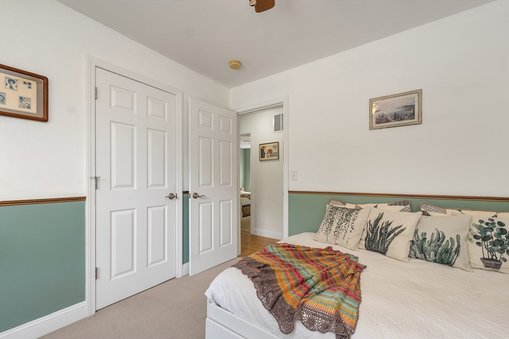 31 Danville Road Hampstead, NH 03826 - Photo 26 of 42 a bedroom with a bed and cabinets