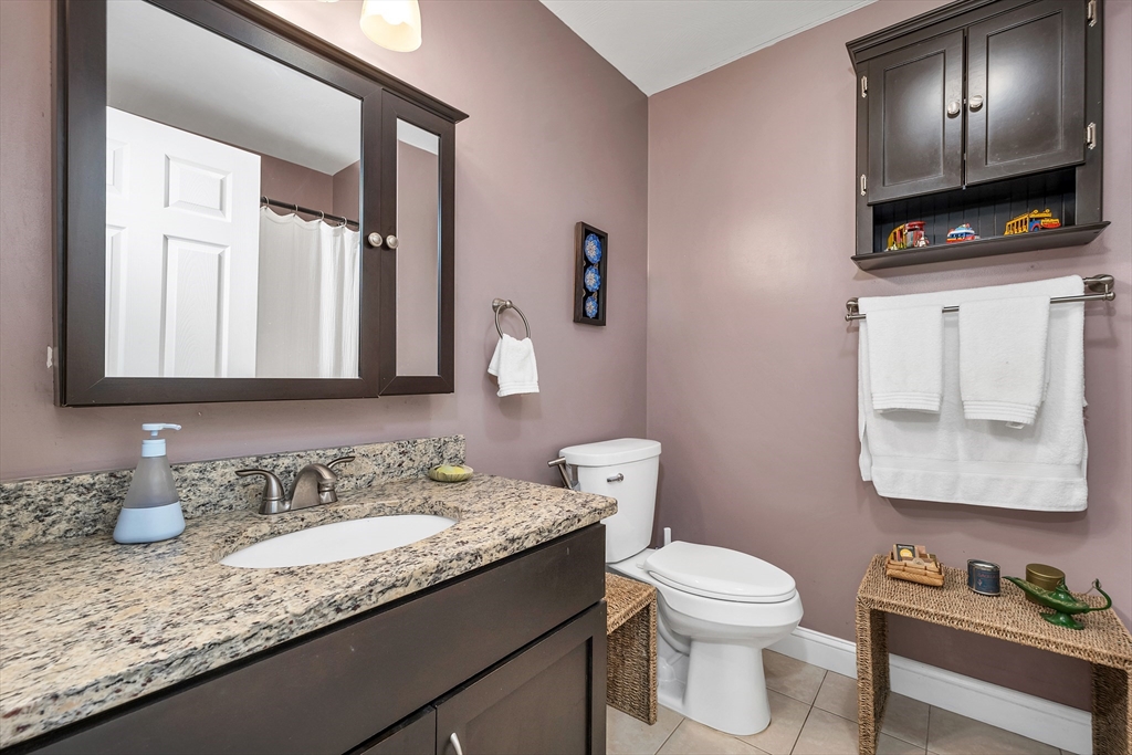 31 Danville Road Hampstead, NH 03826 - Photo 27 of 42 a bathroom with a granite countertop toilet sink and mirror