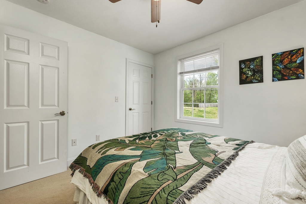 31 Danville Road Hampstead, NH 03826 - Photo 29 of 42 a bed sitting in a bedroom next to a window