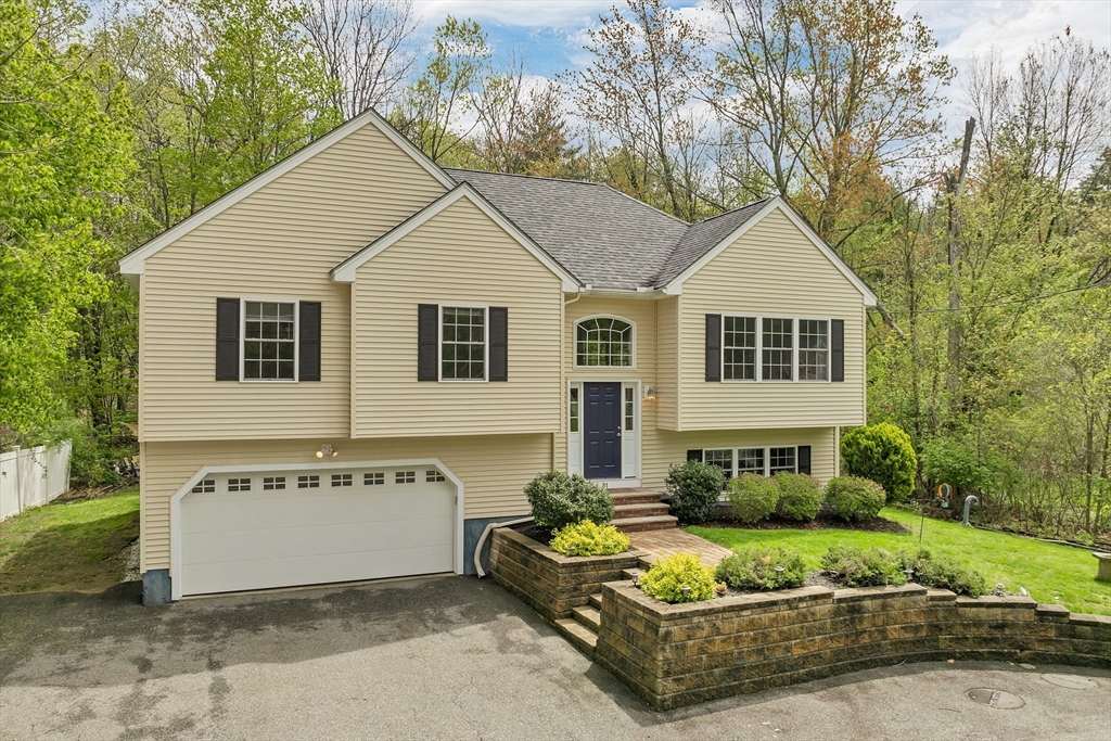 31 Danville Road Hampstead, NH 03826 - Photo 30 of 42 a view of a white house with a yard and plants