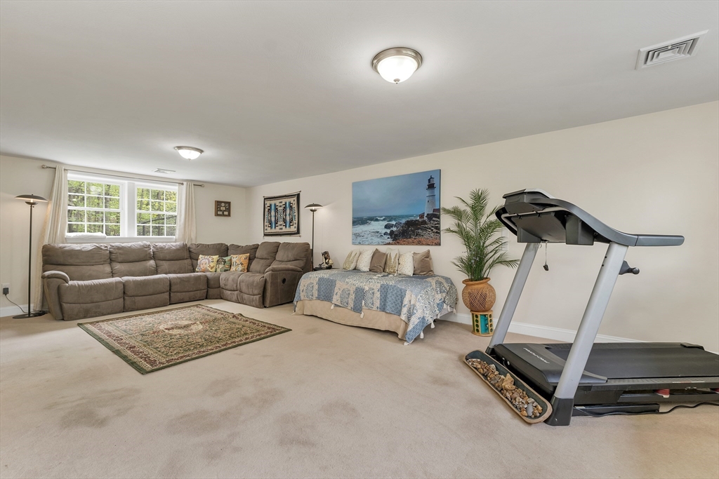 31 Danville Road Hampstead, NH 03826 - Photo 33 of 42 a living room with furniture gym equipment and a window