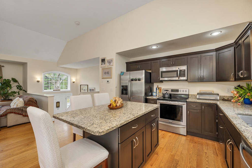 31 Danville Road Hampstead, NH 03826 - Photo 5 of 42 a kitchen with stainless steel appliances granite countertop a kitchen island sink stove and refrigerator