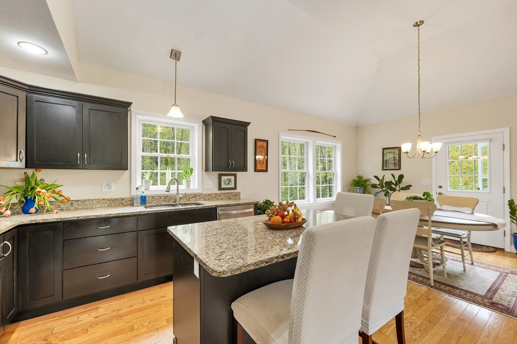 31 Danville Road Hampstead, NH 03826 - Photo 6 of 42 a kitchen with a table chairs stove and cabinets