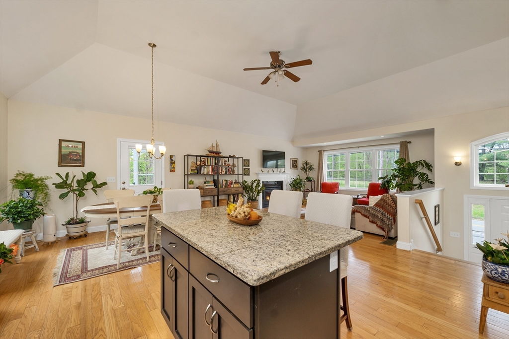 31 Danville Road Hampstead, NH 03826 - Photo 7 of 42 a view of a dining room and livingroom with furniture wooden floor a chandelier