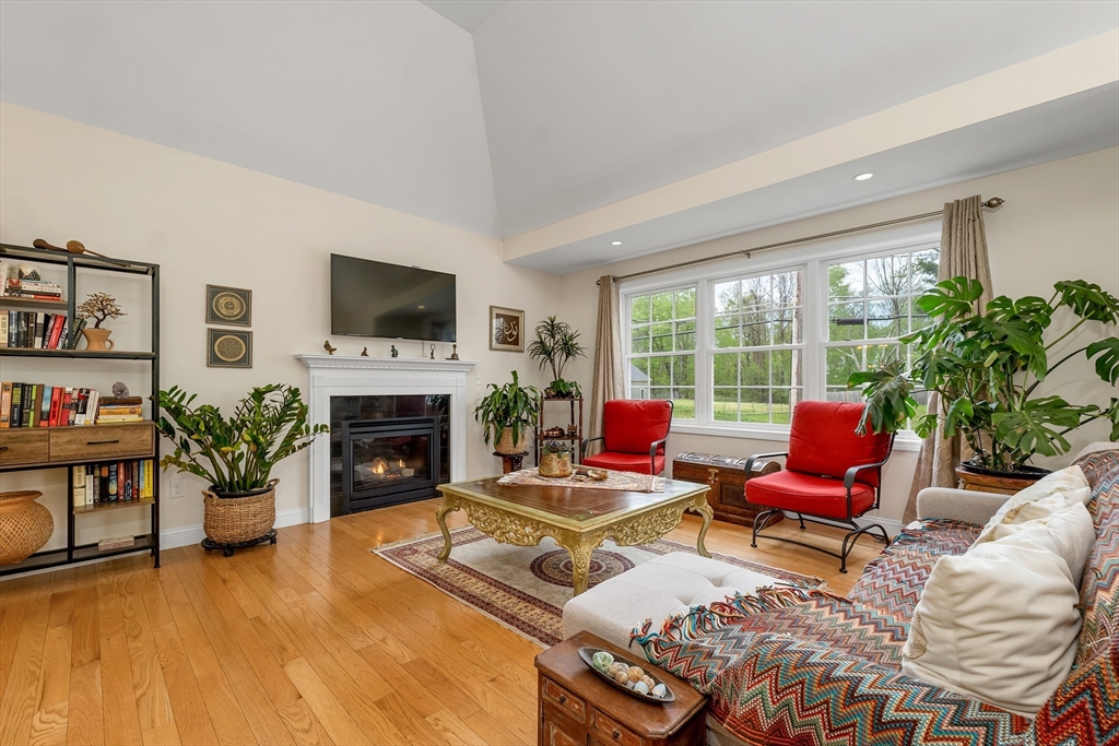 31 Danville Road Hampstead, NH 03826 - Photo 10 of 42 a living room with furniture a fireplace and a flat screen tv