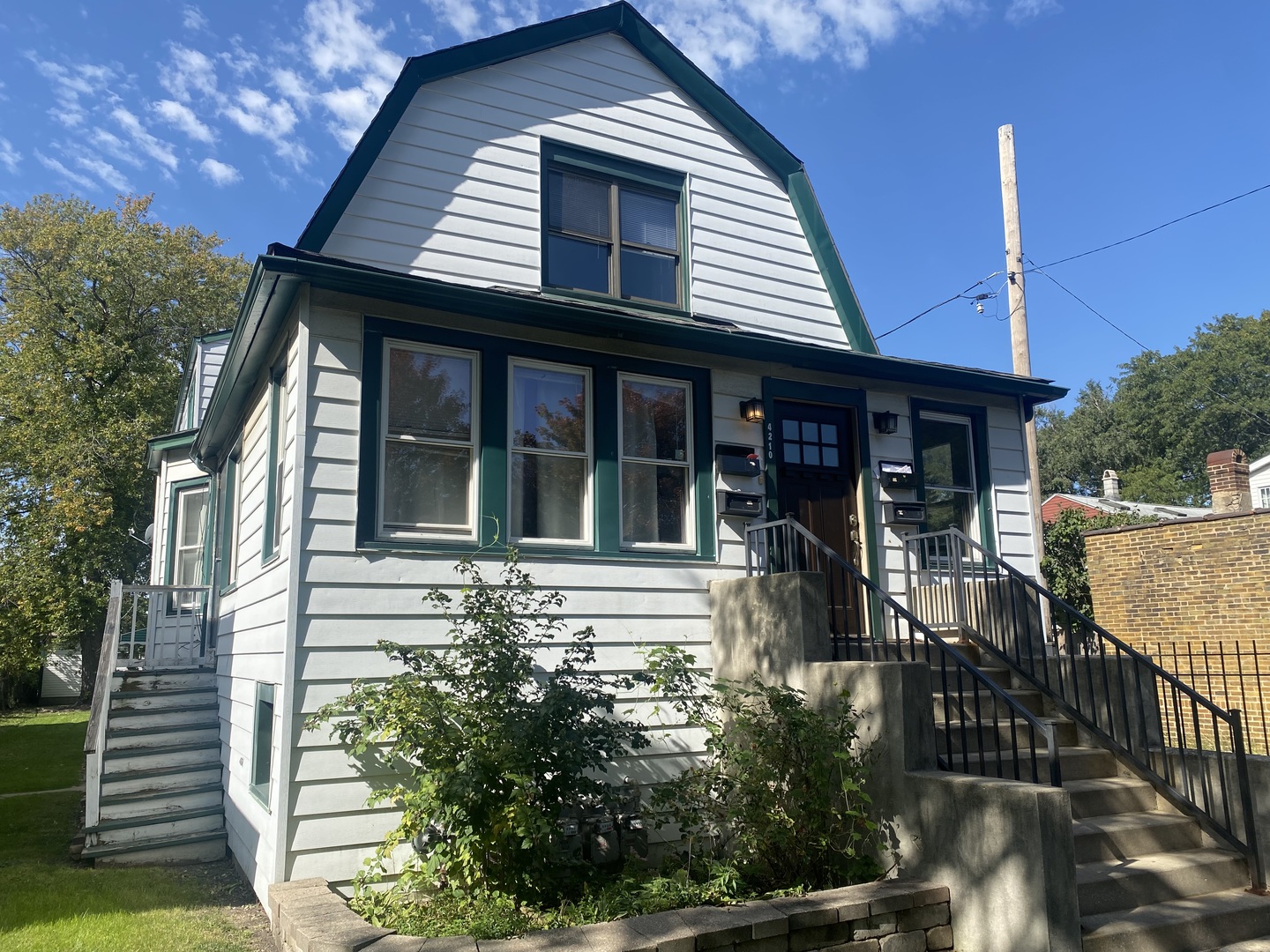 4210 North Kilpatrick Avenue, Unit 2F Chicago, IL 60641 - Photo 1 of 15 a front view of a house with garden