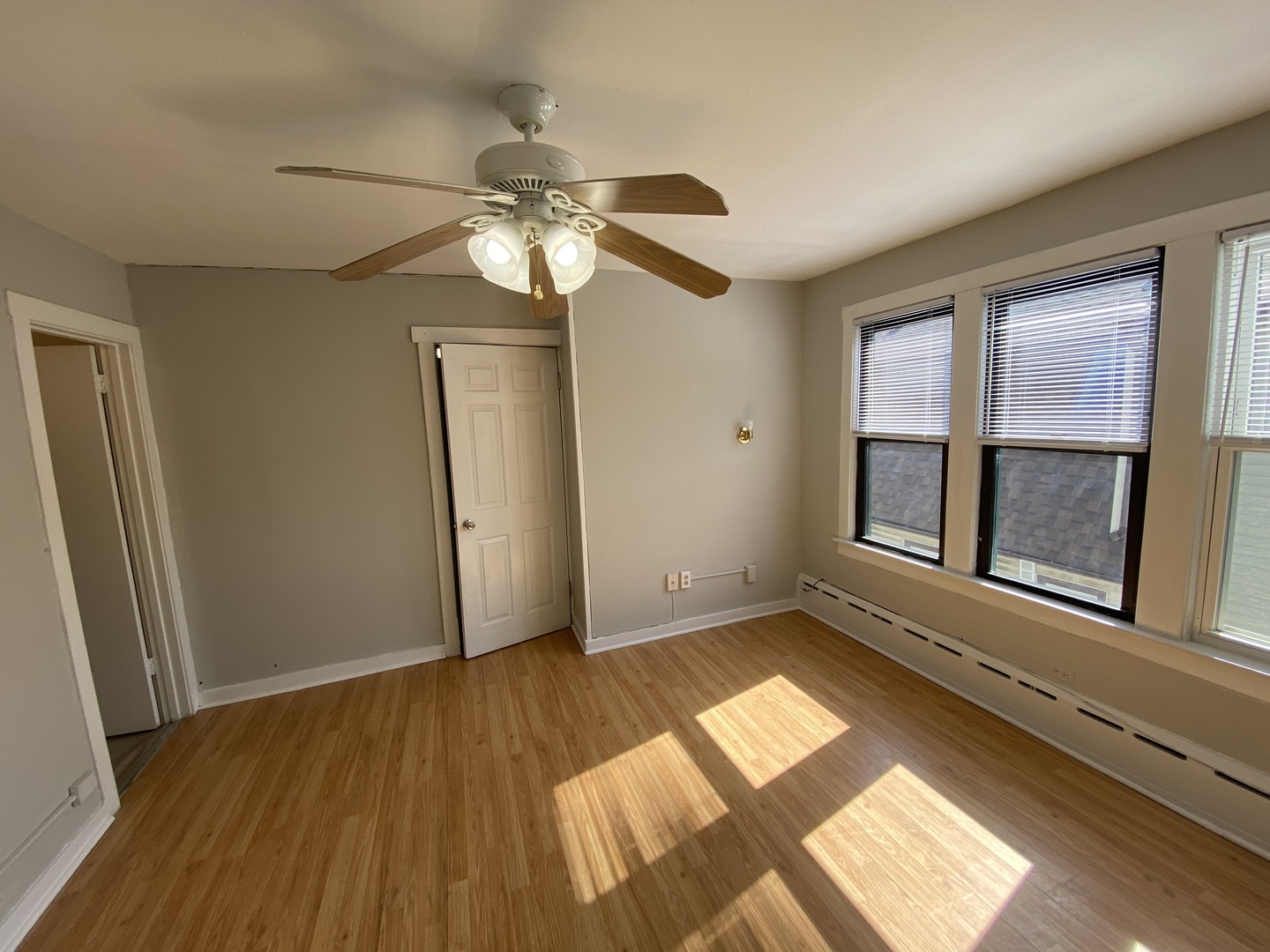 4210 North Kilpatrick Avenue, Unit 2F Chicago, IL 60641 - Photo 14 of 15 a view of an empty room with wooden floor and a window