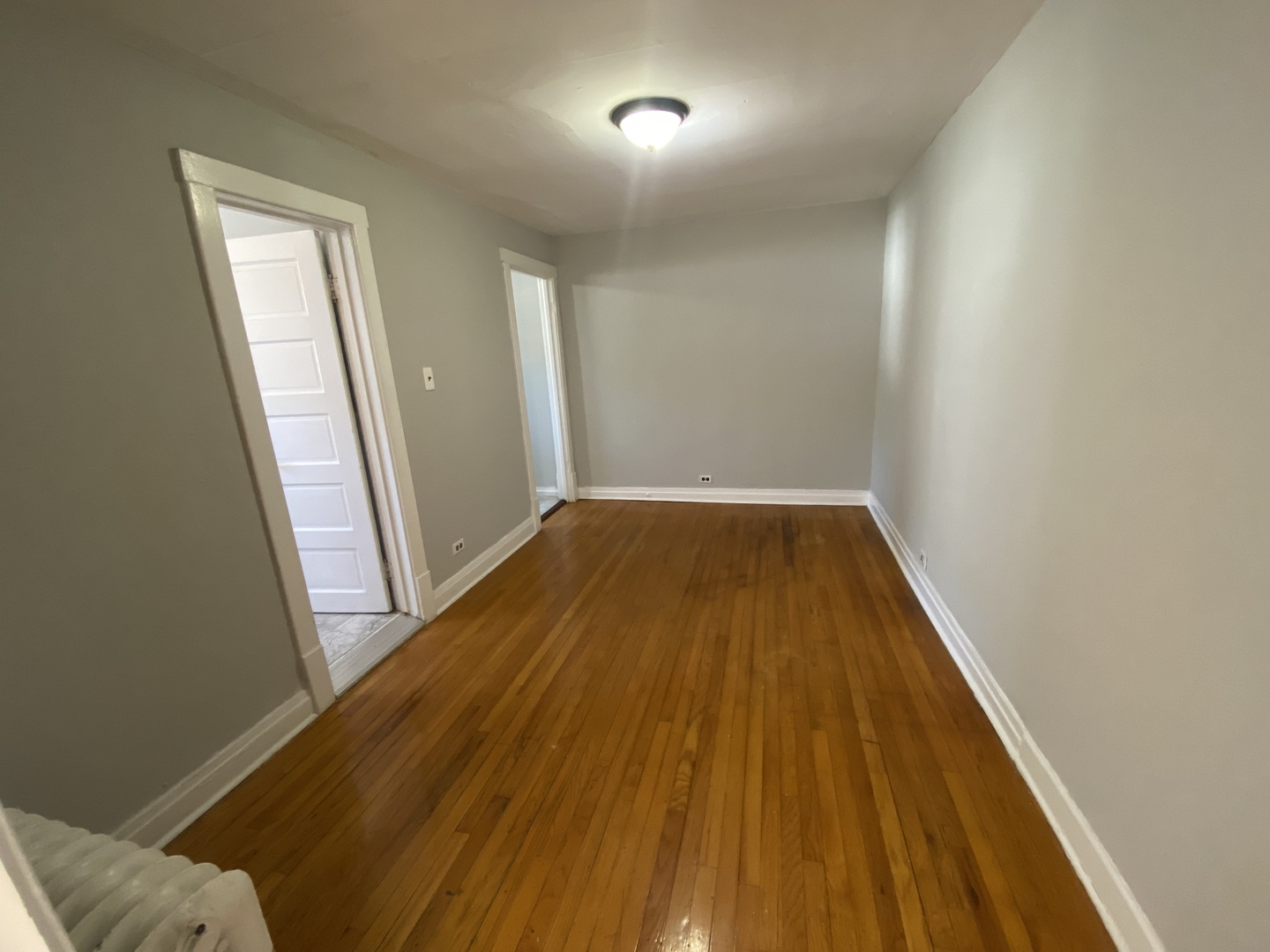 4210 North Kilpatrick Avenue, Unit 2F Chicago, IL 60641 - Photo 15 of 15 an empty room with wooden floor and windows