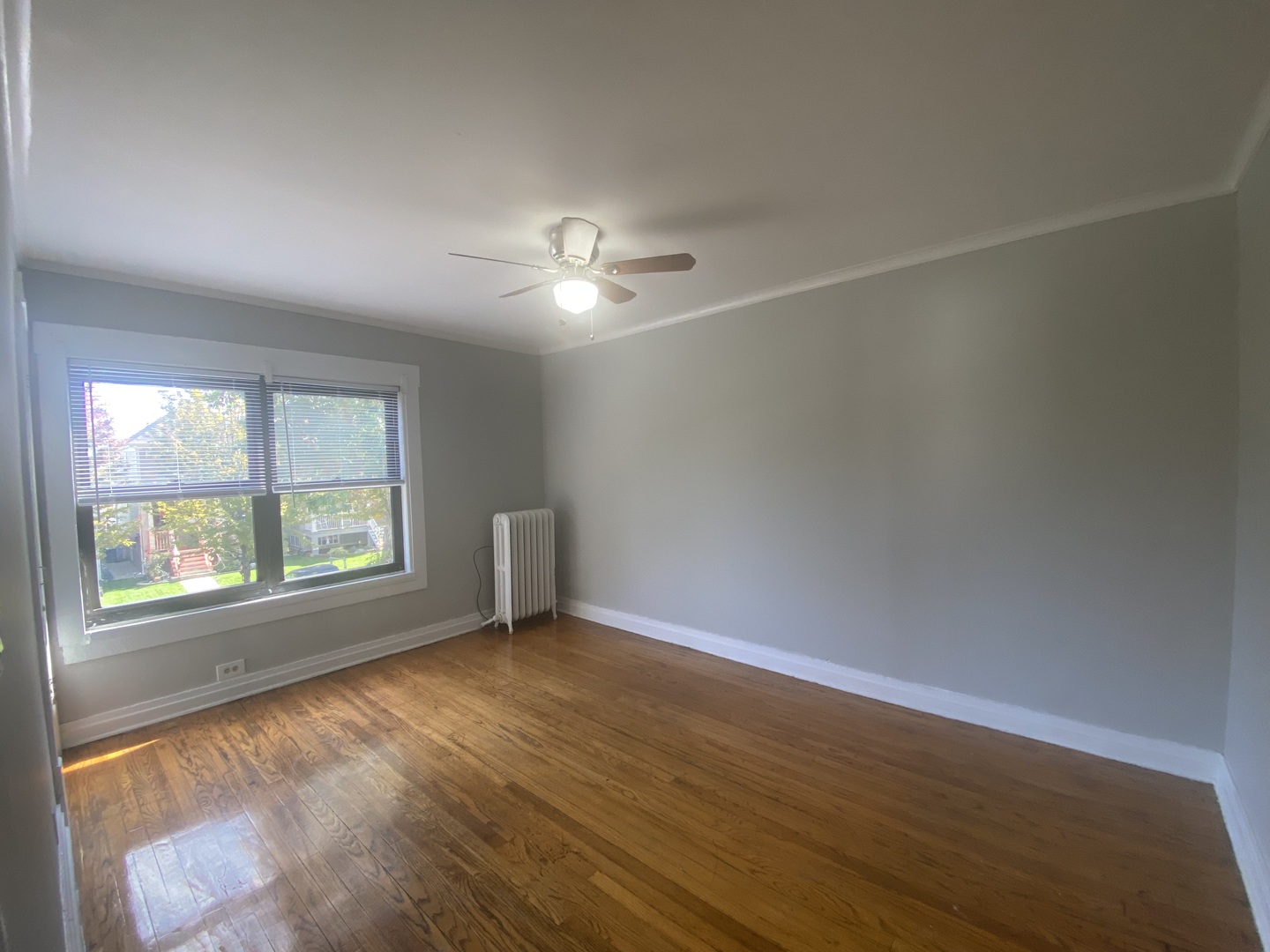 4210 North Kilpatrick Avenue, Unit 2F Chicago, IL 60641 - Photo 3 of 15 an empty room with wooden floor and windows