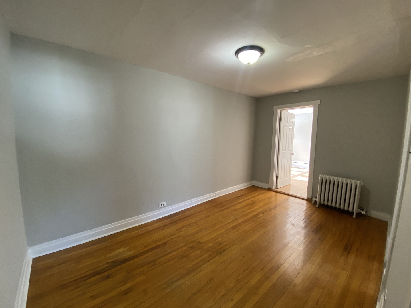 4210 North Kilpatrick Avenue, Unit 2F Chicago, IL 60641 - Photo 7 of 15 an empty room with wooden floor and windows