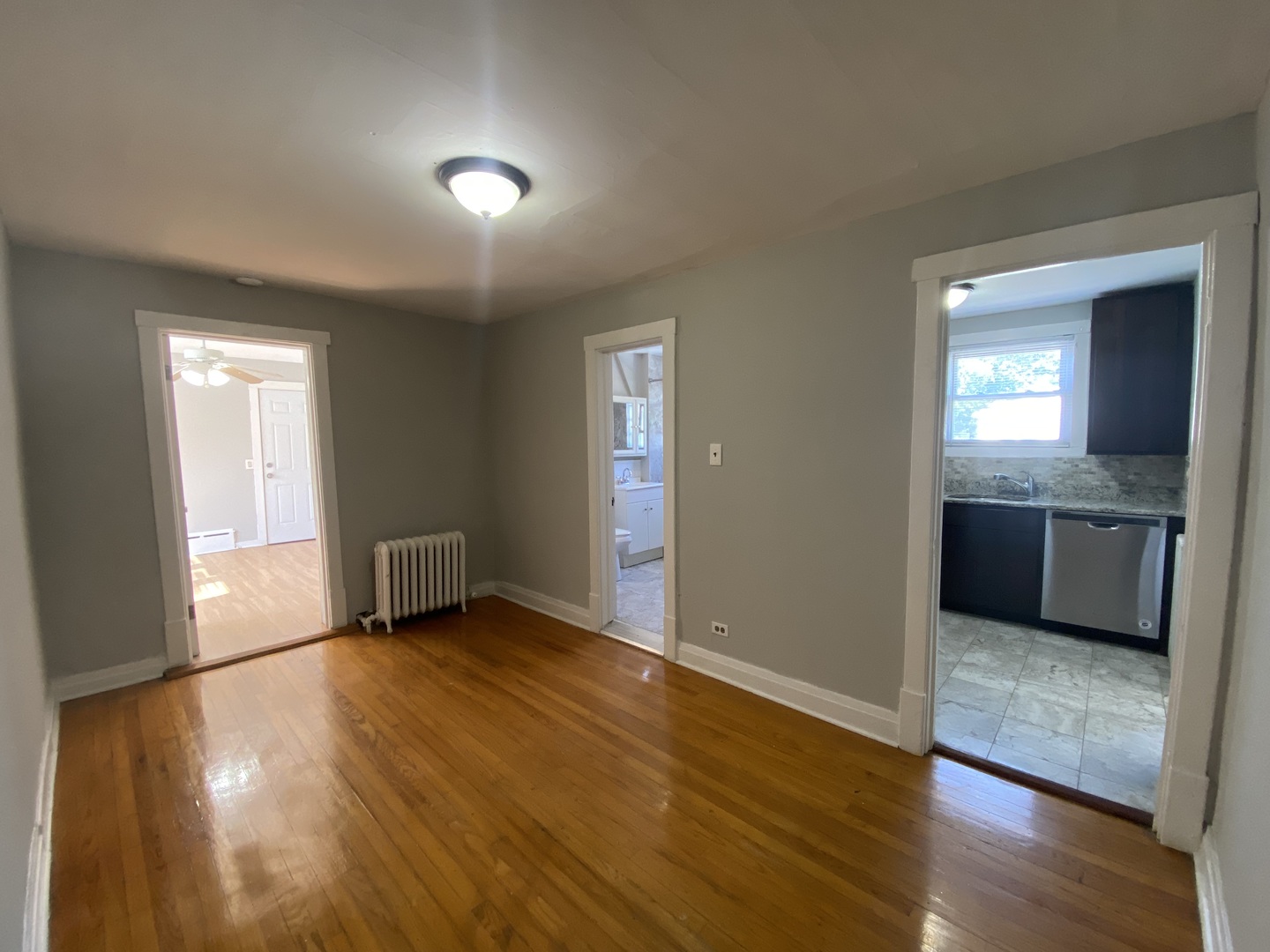 4210 North Kilpatrick Avenue, Unit 2F Chicago, IL 60641 - Photo 8 of 15 an empty room with wooden floor and windows