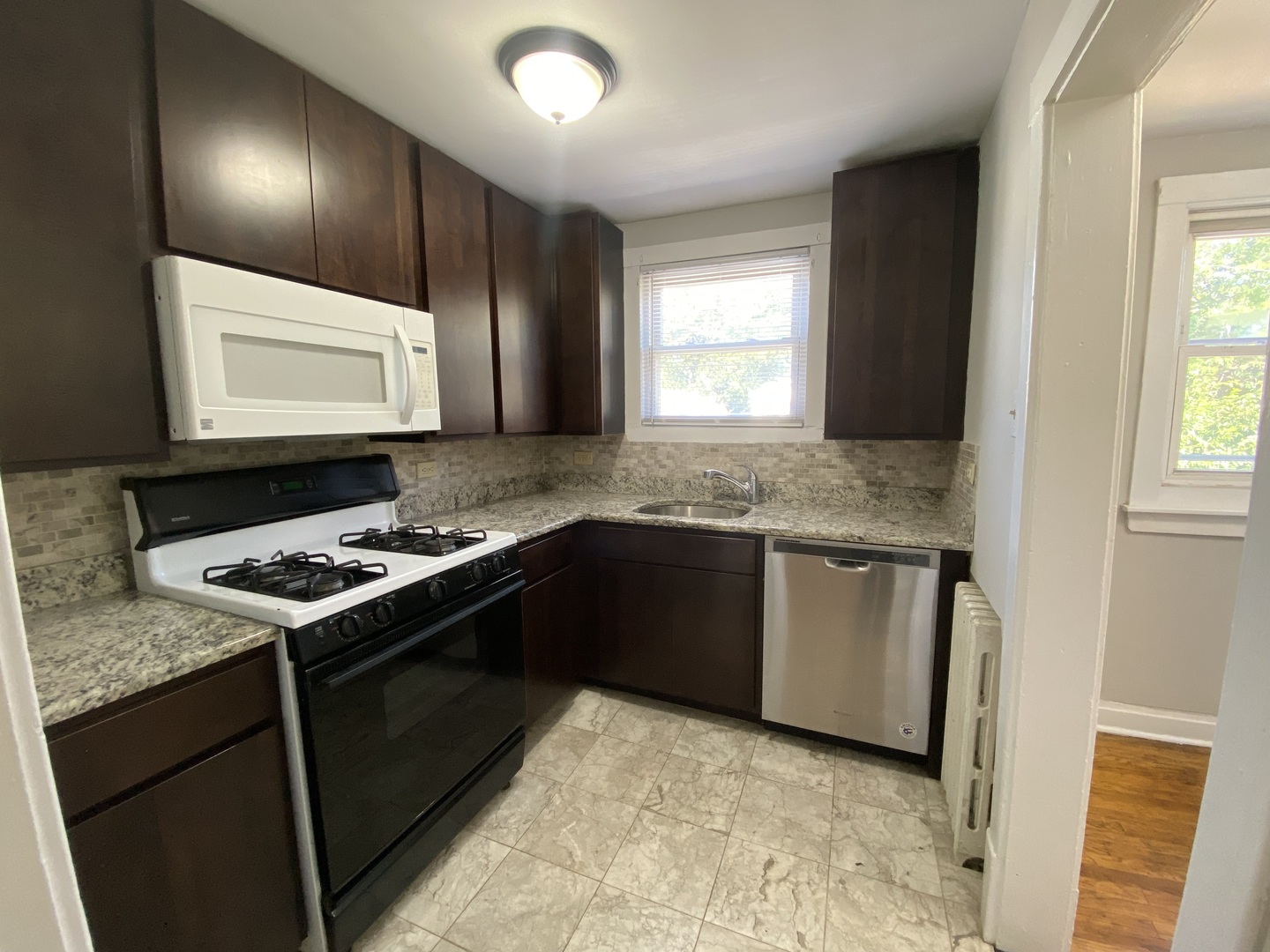 4210 North Kilpatrick Avenue, Unit 2F Chicago, IL 60641 - Photo 9 of 15 a kitchen with granite countertop a stove and a sink