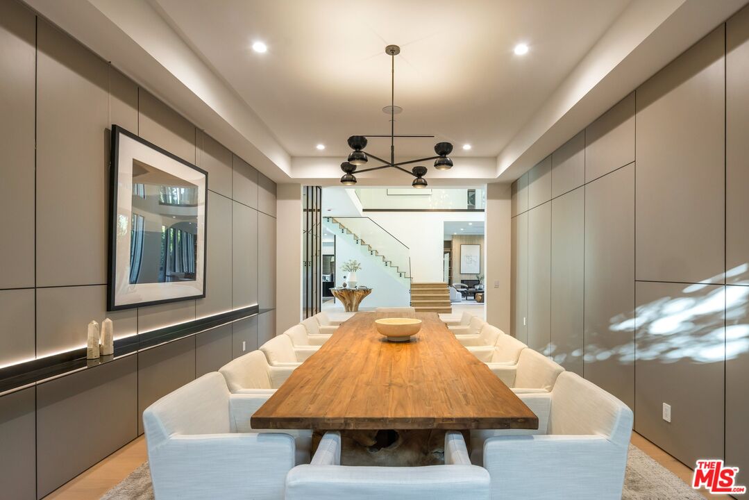 17055 Rancho Street Encino, CA 91316 - Photo 26 of 73 a very nice looking dining room with a large window and chandelier