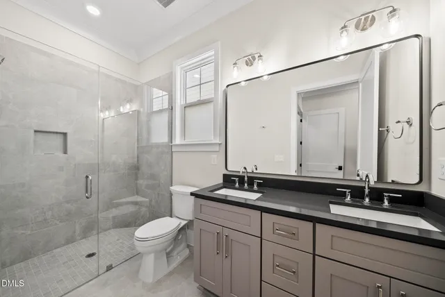 an empty room with wooden floor ceiling fan and windows