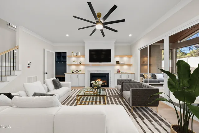 a living room with furniture a fireplace and a flat screen tv