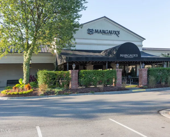 a front view of a building with small garden