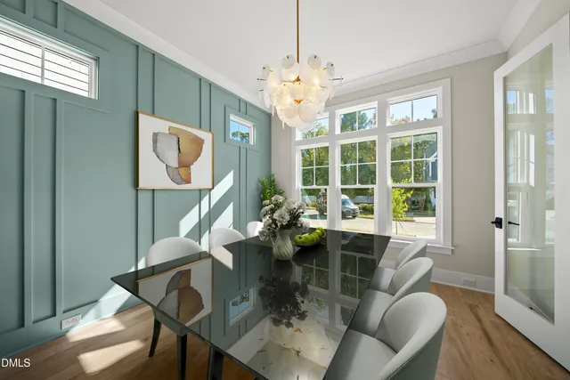 a dining room with furniture a chandelier and wooden floor