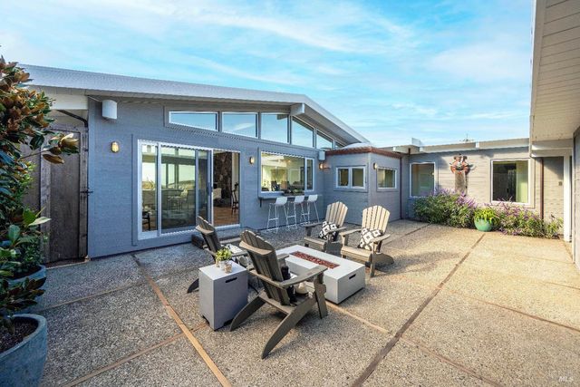 a building outdoor space with patio furniture and potted plants