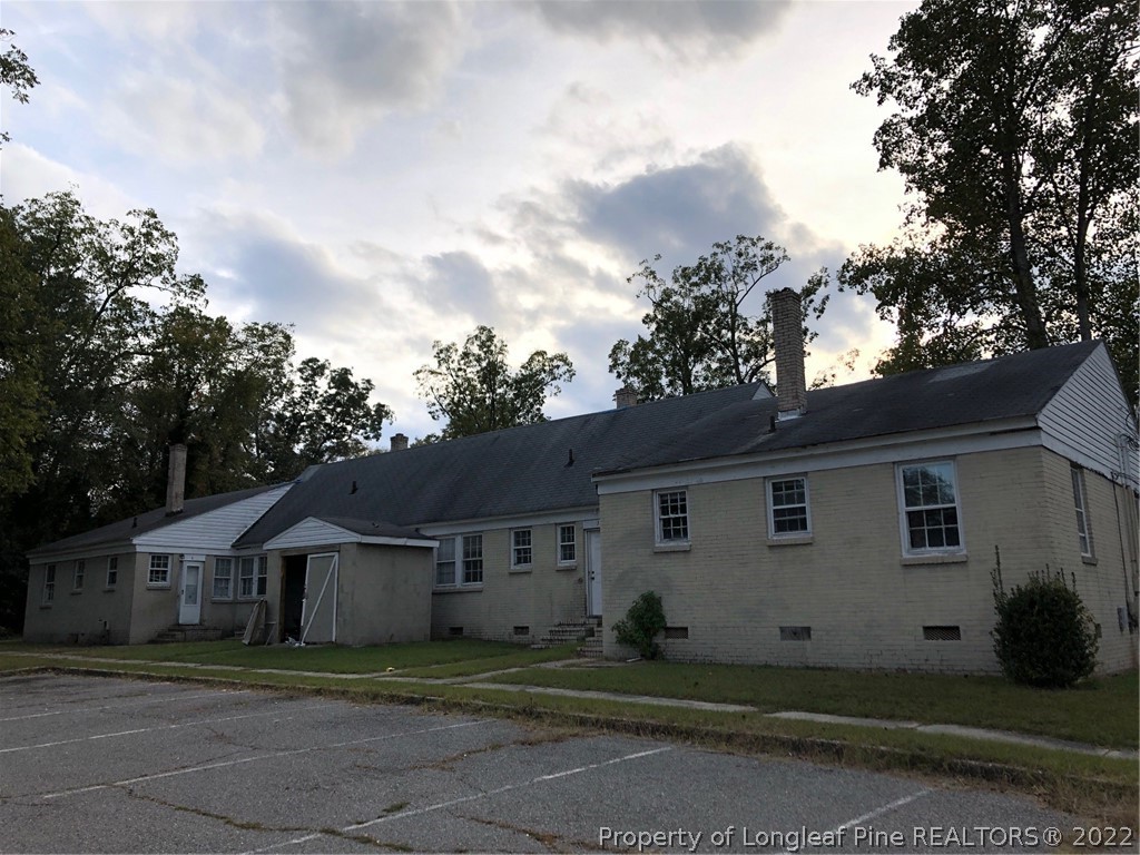 700 Ann Street Rockingham, NC 28379 - Photo 15 of 19 a view of house with a big yard plants and large trees