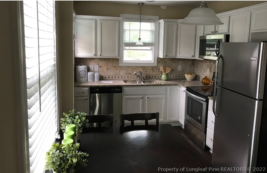 700 Ann Street Rockingham, NC 28379 - Photo 9 of 19 a kitchen with a sink stainless steel appliances and cabinets