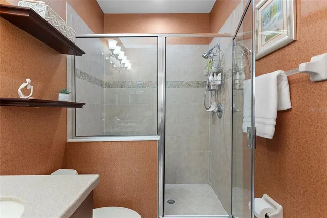 a bathroom with a shower a toilet and a sink