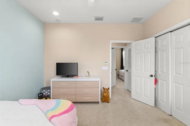 a bedroom with a bed and a tv