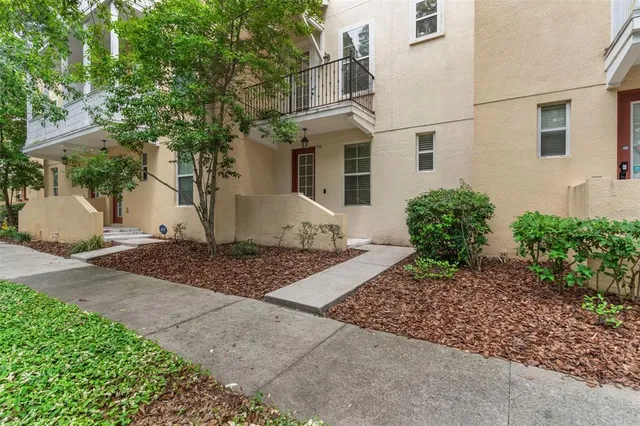 a view of a white house with a street